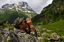 Park ranger, Ramazan Khubiev, searching the hills for mammals, Arkhyz valley, the western part of the Teberdinsky Biosphere reserve, Caucasus, Russia, July 2008 (Model released)