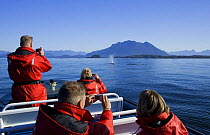 Tourists watching a Gray Whale {Eschrichtius robustus} at Clayoquot Sound, Vancouver Island, British Columbia, Canada