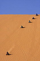 Dune buggies competing, driving down high sand dune, Liwa Oasis, United Arab Emirates, UAE, December 2007