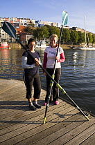 Annie Januszewski and Mel King before rowing the Atlantic in the WoodVale Challenge. Bristol Floating Harbour, 17th September 2009. Model Released.