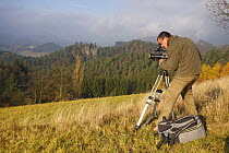 Cameraman, Alberto Saiz, filming for Wild Wonders of Europe, with Mariina Skala in the distance, Rynartice, Ceske Svycarsko / Bohemian Switzerland National Park, Czech Republic, November 2008