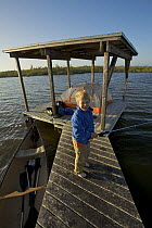 Russell Laman fishing from the Hell's Bay Chickee camping platform in the mangroves, Hell's Bay Canoe Trail, Everglades National Park, Florida, USA. Model released, April 2008