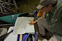 Tim Laman and Russell study their map while on the Hell's Bay Canoe Trail, Everglades National Park. Florida, USA. Model released, April 2008