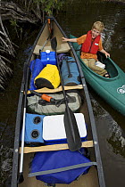 Russell Laman in kayak with loaded canoe for camping trip on the Hell's Bay Canoe Trail, Everglades National Park, Florida, USA. Model released, April 2008