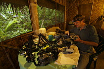 Photographer Tim Laman prepares underwater camera at the Kosrae Village Ecolodge, a rainforest lodge on Kosrae Island, Federated States of Micronesia. Model released, June 2005