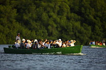 Tourists taking a boat tour of the Caroni Swamp. Caroni Bird Sanctuary, Trinidad, Trinidad and Tobago. February 2006