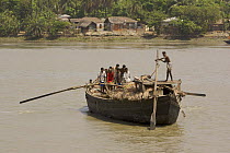 A large freight boat taking goods across river, propelled by oars and manpower, Khulna, Khulna Province, Bangladesh. March 2006
