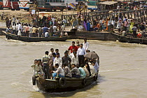 A passenger ferry / shuttle taking people across the Rupsha river at Khulna, Khulna Province, Bangladesh. March 2006