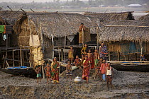 Nolian village with Shrimp fry fishing boats pulled up on the mudflats of the Sibsa River at low tide, Sundarbans, Khulna Province, Bangladesh, March 2006