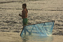 Girl pulling a shrimp fry hand net, Nolian Village, Sundarbans, Khulna Province, Bangladesh, March 2006