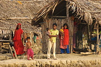 Family in the village of Chandpai on the Passur River, where shrimp fry fishing to supply shrimp for the shrimp ponds is the main industry. Villagers live in simple mud and thatch huts that are washed...