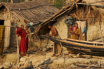 Villagers the village of Chandpai on the Passur River, where shrimp fry fishing to supply shrimp for the shrimp ponds is the main industry. Villagers live in simple mud and thatch huts that are washed...