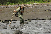 Primatologist, Tom Butynski, wading across the Rio Ole, Bioko Island, Equatorial Guinea, Rapid Assessment Visual Expedition, International League of Conservation Photographers, January 2008. Model rel...