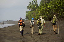 Caldera expedition members hike along the beach on the South coast of Bioko Island, Equatorial Guinea, Rapid Assessment Visual Expedition, International League of Conservation Photographers, January 2...