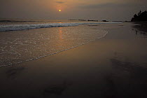 Sunset from the volcanic black sand beach on South coast of Bioko Island, Equatorial Guinea, January 2008