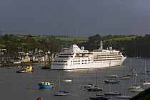 Cruise ship "Silver Cloud" assisted by tugs, entering Fowey harbour in the early morning, Cornwall, UK. September 2009.