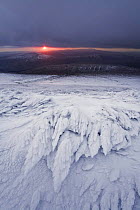 View from the summit of Corn Du towards The Black Mountain in winter at sunset, hard rime ice formations in foreground, Brecon Beacons National Park, Powys, Wales, UK, October 2008