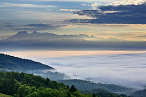 Dawn over mist shrouded Ljubljana Basin looking towards Kamnik Alps, Tehovec, Slovenia, June 2008