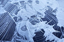 Ice patterns on surface of frozen lake, Snowdonia National Park, Gwynedd, Wales, UK, December 2008