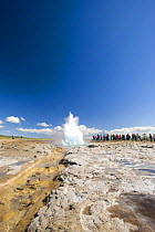 Tourists watching eruption of The Strokkur, the biggest geyser active in the Geysir area, SW Iceland, sequence 1/11. July 2008