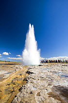 Tourists watching eruption of The Strokkur, the biggest geyser active in the Geysir area, SW Iceland, sequence 2/11. July 2008