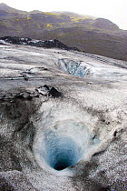 Deep hole in the ice of the Solheimajokull, a glacier tongue from the Myrdalsjokull Glacier, South Iceland. July 2008