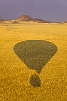 Shadow of hot air balloon over Namib desert, Sossusvlei, Sesriem, Namib desert, Namibia, August 2008