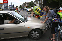Protesters confronting a motorist whilst cycling through London towards Blackheath for Climate Camp 2009. London, UK. 26/08/09