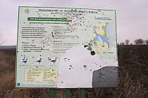 Battered sign showing the information about the area around Durankulak Lake, Bulgaria, February 2009