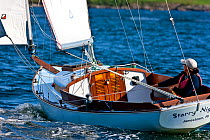 Woman sailing yacht "Starry Night" off Newport, Rhode Island, USA. 2009.