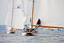 Woman leaning against boom of yacht "Clarity" during the 6 Metre Class World Championships, Newport, Rhode Island, USA. September 2009.