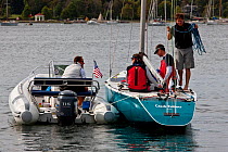 Official chatting with the crew of a 6 Metre Class yacht, World Championships, Newport, Rhode Island, USA. September 2009.