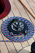Rope neatly coiled around compass aboard 6 Metre Class yacht at the World Championships. Newport, Rhode Island, USA. September 2009.