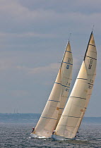 Bowmen signalling to their crews onboard yachts racing at the 12 Metre World Championships, Newport, Rhode Island, USA. September 2009.