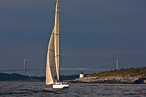 Yacht sailing past the Castle Hill lighthouse during the 12 Metre World Championships, Newport, Rhode Island, USA. September 2009.