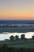 Elbe River at sunrise with mist over fields, Elbe Biosphere Reserve, Lower Saxony, Germany, July 2008