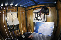 Fisheye view of inside of hide with laptop and camera, La Serena, Extremadura, Spain, April 2009