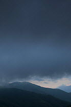 Dark clouds over hills, Pollino National Park, Basilicata, Italy, June 2009