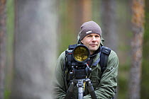 Photographer, Erlend Haarberg with camera equipment, in Bergslagen, Sweden, April 2009