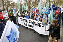 The Wave, climate change march ahead of the Copenhagen climate summit. People carrying large banner stating 'Climate Change - Act Now' London, UK, 5th December 2009