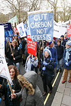 Protesters part of 'The Wave' climate change march ahead of the Copenhagen climate summit, one sign stating 'Cut Carbon not Forests' London, UK, 5th December 2009