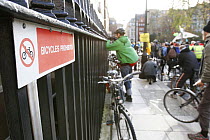 'Bicycles prohibited' sign on railings as The Wave, climate change march ahead of the Copenhagen climate summit, passes by, London, UK, 5th December 2009