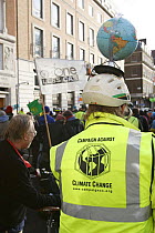 The Wave, climate change march ahead of the Copenhagen climate summit. Person with globe on cycle helmet, London, UK, 5th December 2009