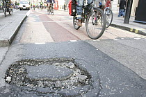 Hole / pothole in tarmac, hazard to cyclists in road  London