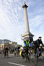 Cyclist, part of 'The Wave' climate change march ahead of the Copenhagen climate summit, passing Nelson's Column in Trafalgar Square, London, UK, 5th December 2009