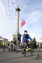 Cyclists, part of 'The Wave' climate change march ahead of the Copenhagen climate summit, passing Nelson's Column in Trafalgar Square, London, UK, 5th December 2009