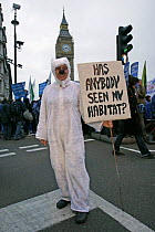Person dressed as a Polar bear holding a sign asking 'Has anybody seen my habitat?' Part of 'The Wave' climate change march ahead of the Copenhagen climate summit, near Big Ben, London, UK, 5th Decemb...