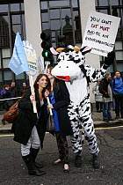 Protesters, one dressed as a cow holding a sign stating 'You can't eat meat and be an environmentalist'. Part of The Wave climate change march ahead of the Copenhagen climate summit, London, UK, 5th D...
