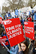 Protesters carrying signs, part of 'The Wave' climate change march ahead of the Copenhagen climate summit, stating 'Time for climate justice' and 'Climate justice now' London, UK, 5th December 2009