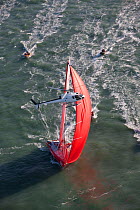 Helicopter flying low over "Veolia Environment" (Roland Jourdain and Jean-Luc Nelias) at the start of the Transat Jacques Vabre race, departing Le Havre, France. 8th November 2009.